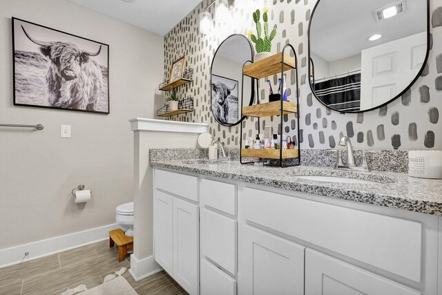 bathroom featuring toilet, vanity, hardwood / wood-style floors, and curtained shower