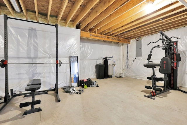 workout room with electric panel and concrete floors