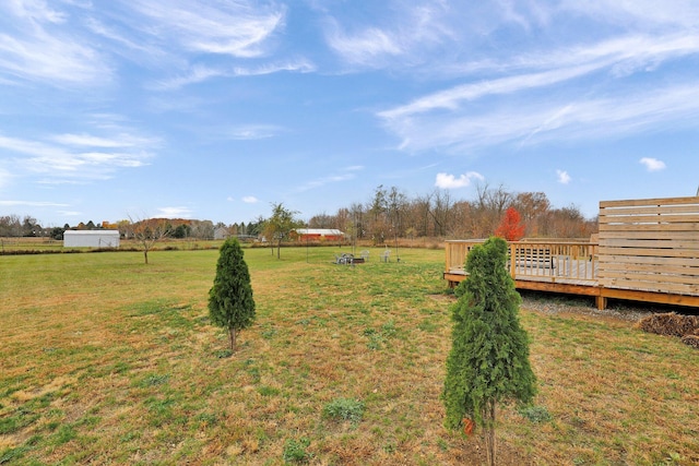 view of yard featuring a wooden deck and a rural view