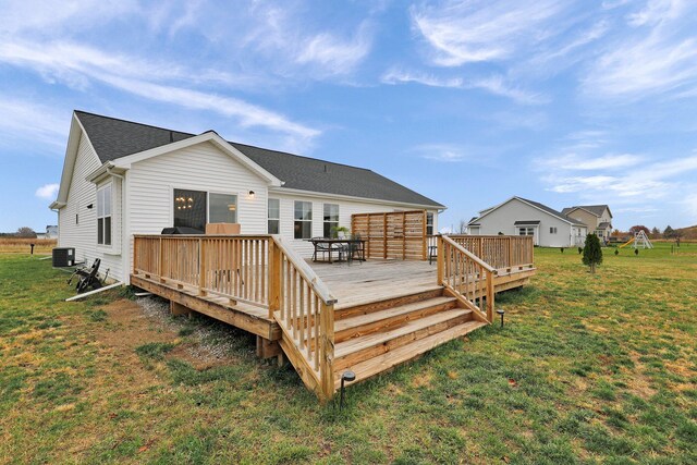 back of house featuring central air condition unit, a lawn, and a deck