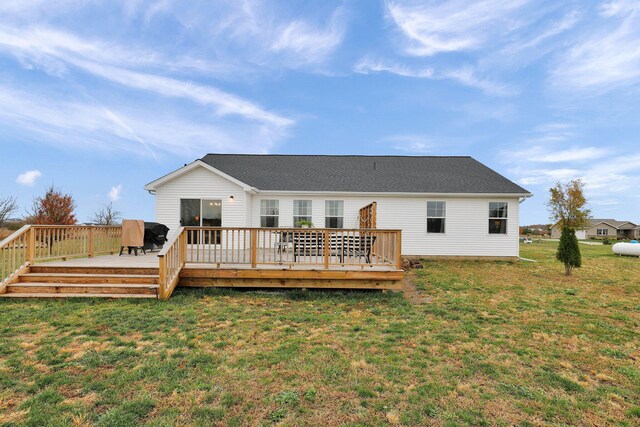 back of house with a deck and a lawn