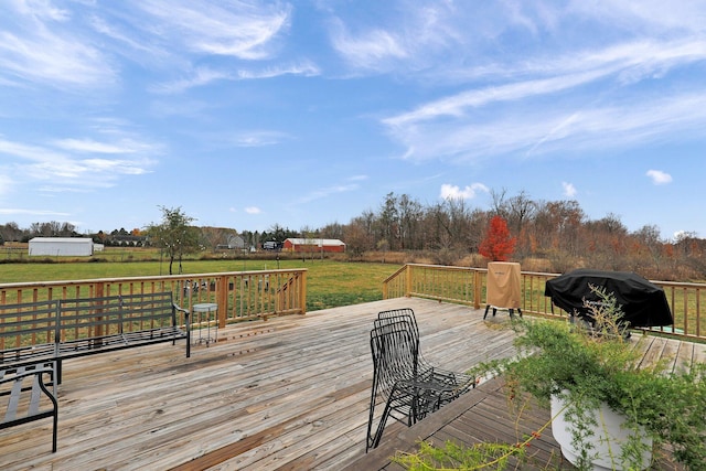 deck featuring a grill and a lawn