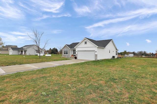 view of front of home with a garage, cooling unit, and a front yard