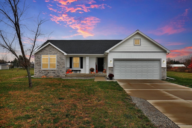 ranch-style house featuring a garage and a yard