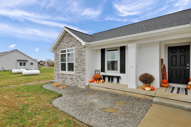 view of exterior entry featuring a yard