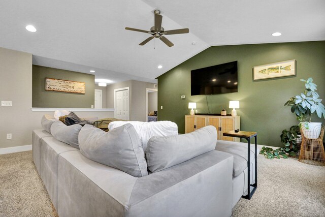 carpeted living room featuring ceiling fan and vaulted ceiling