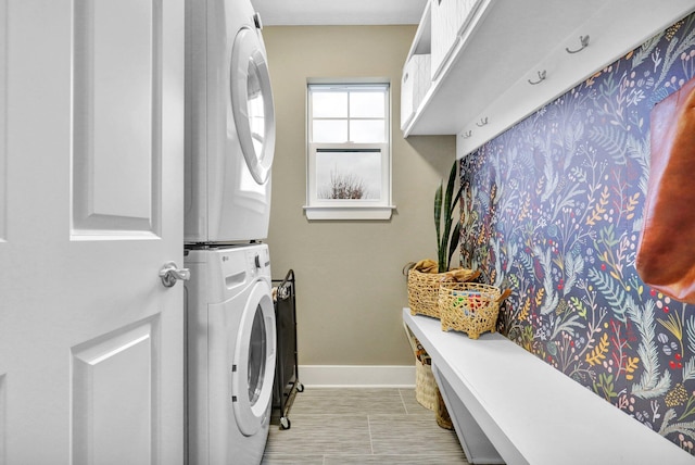 washroom featuring stacked washer and clothes dryer