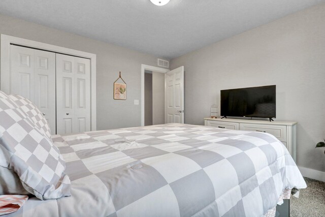 carpeted bedroom featuring a closet