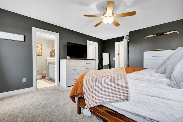 carpeted bedroom with ceiling fan and connected bathroom