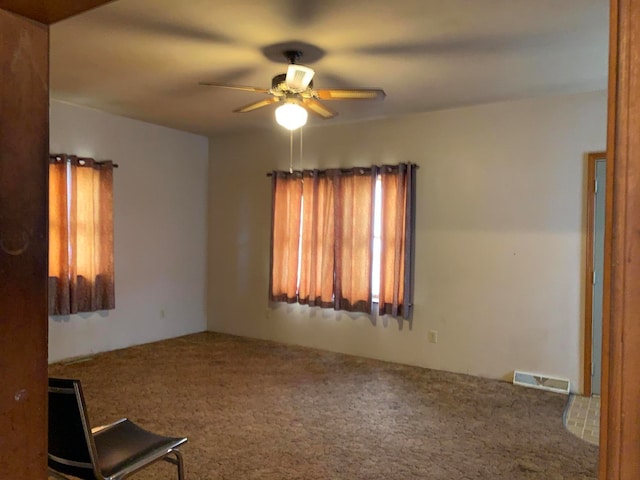 unfurnished room featuring carpet floors and ceiling fan