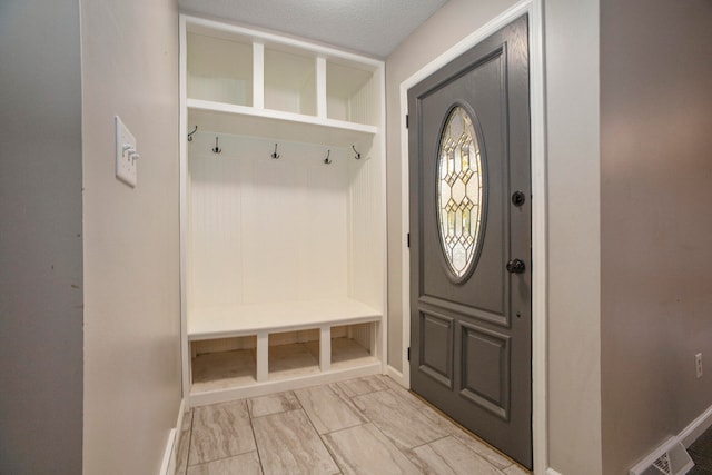 mudroom with a textured ceiling