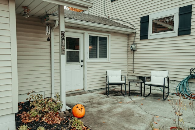 view of exterior entry with a patio