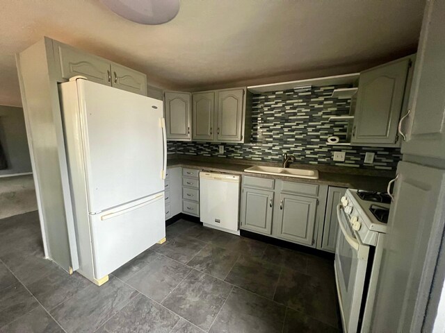 kitchen with decorative backsplash, sink, and white appliances