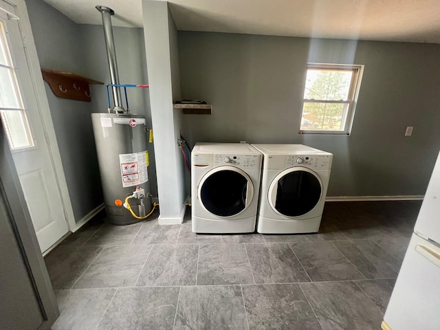 washroom featuring water heater and washing machine and dryer