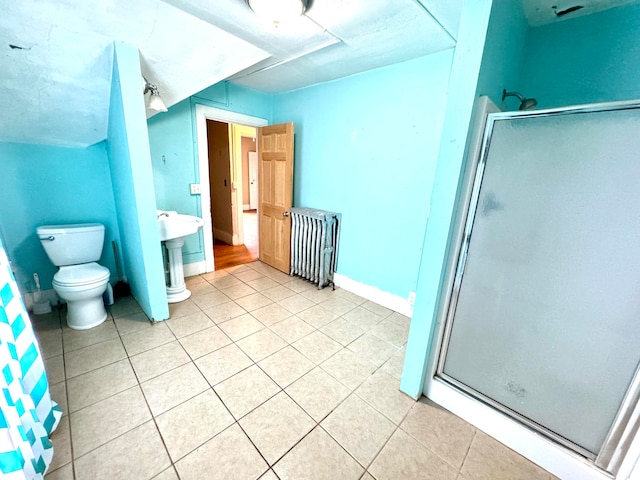 bathroom with toilet, radiator heating unit, walk in shower, and tile patterned flooring