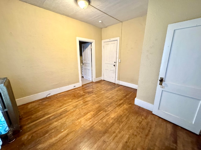 unfurnished bedroom with wood-type flooring