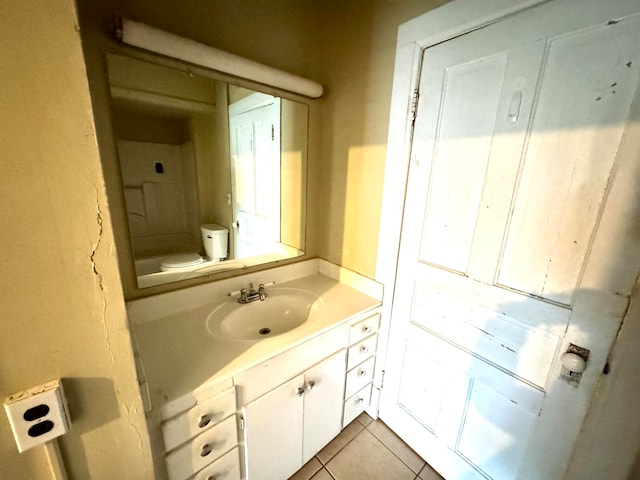 bathroom with vanity, toilet, and tile patterned flooring