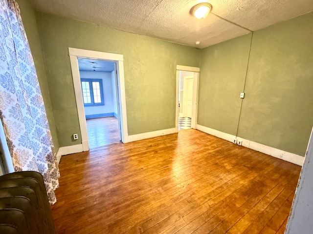 unfurnished room featuring wood-type flooring