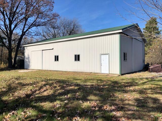 view of outbuilding with a lawn