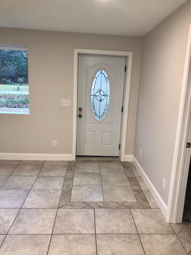 foyer entrance with light tile patterned floors