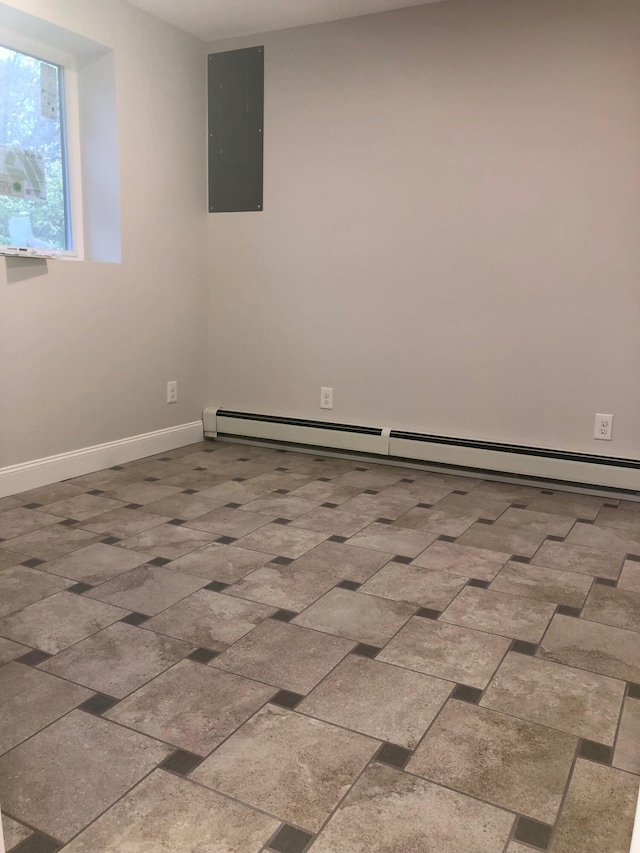 empty room featuring a baseboard heating unit and electric panel