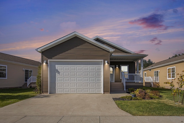 view of front of house with a garage and a lawn