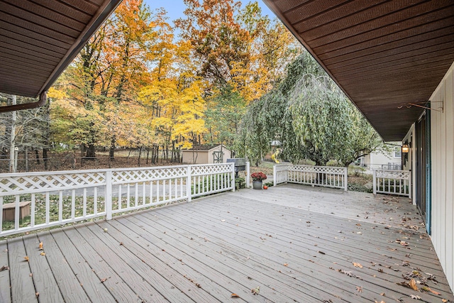 wooden terrace with a storage shed