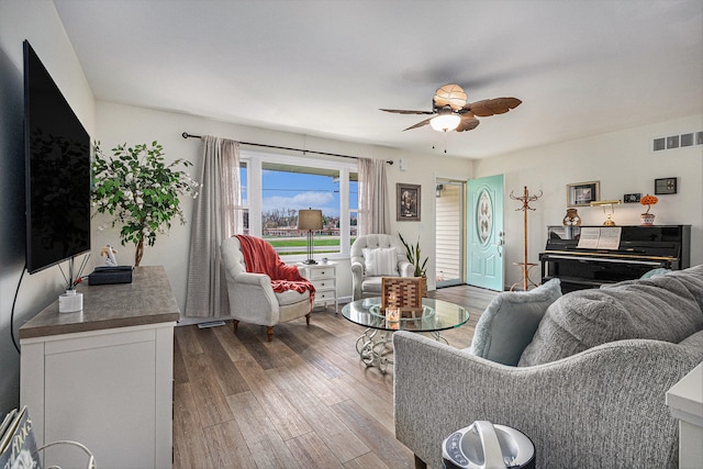 living room with hardwood / wood-style floors and ceiling fan