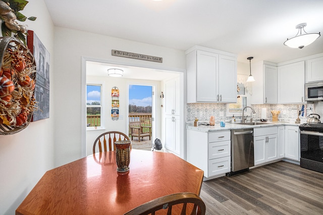 kitchen with white cabinetry, appliances with stainless steel finishes, backsplash, sink, and dark wood-type flooring