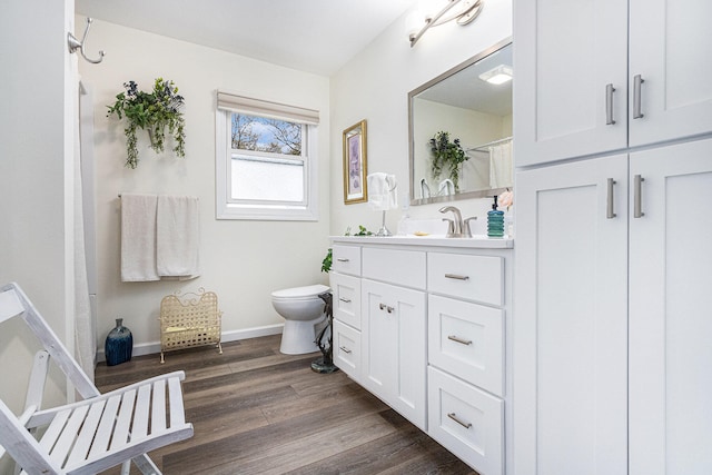 bathroom with toilet, a shower with curtain, vanity, and hardwood / wood-style floors