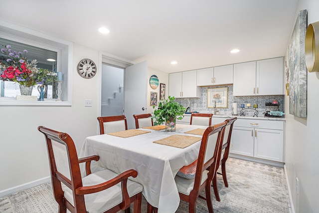 dining room featuring light colored carpet