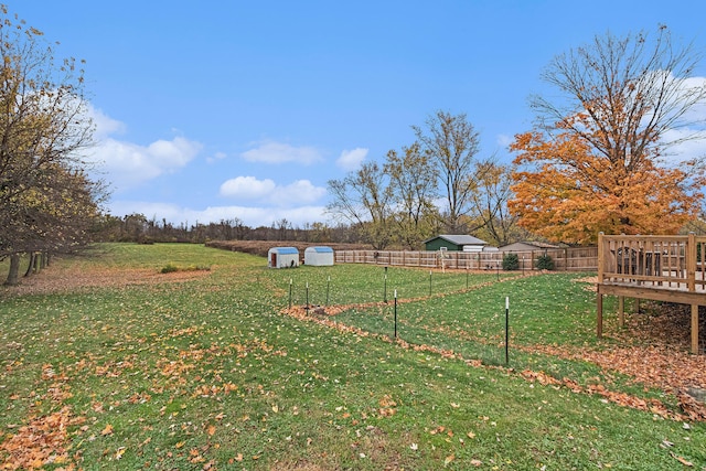 view of yard with a wooden deck and a rural view