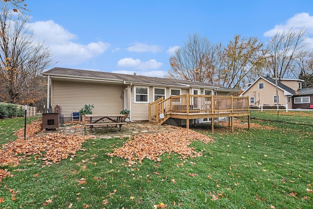 back of house with a lawn and a deck