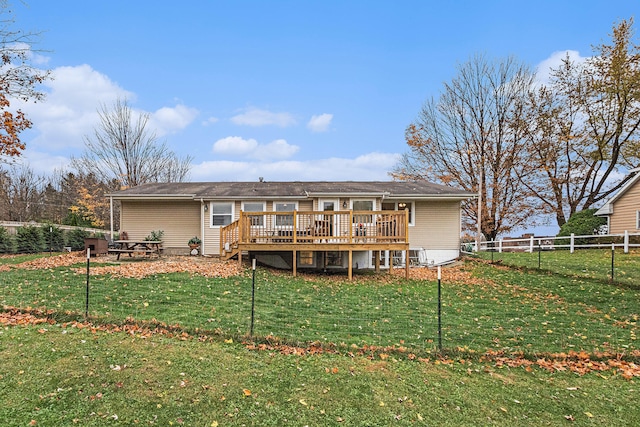 back of house featuring a deck and a yard