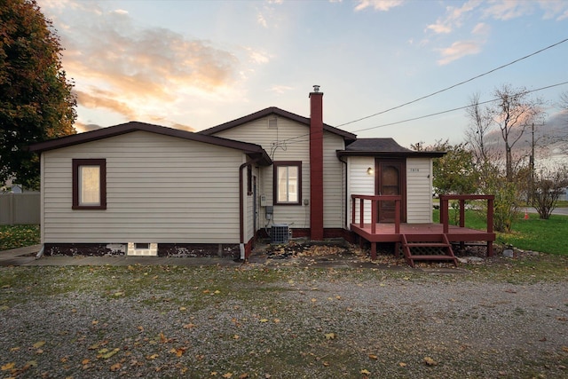 back house at dusk with a deck