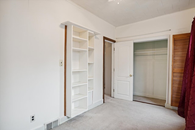 unfurnished bedroom with light colored carpet