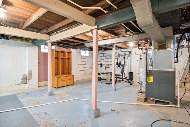 basement featuring gas water heater, heating unit, and a healthy amount of sunlight