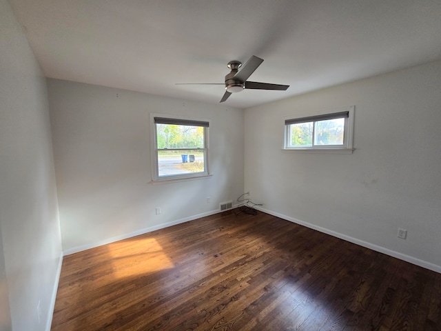 spare room with dark hardwood / wood-style floors and ceiling fan