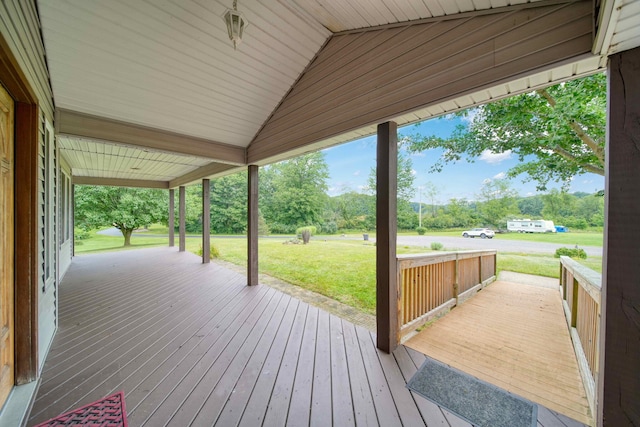 wooden terrace with a yard