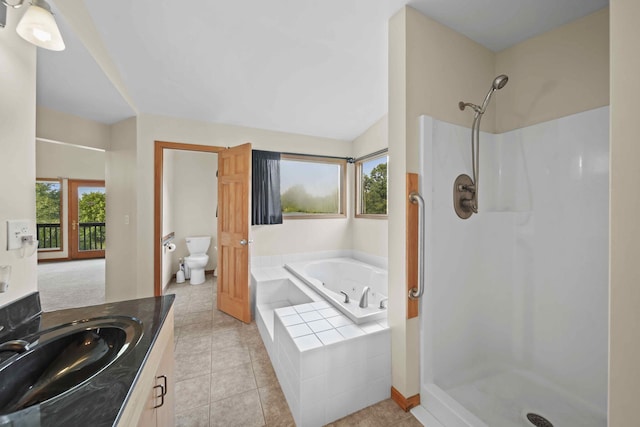 full bathroom featuring lofted ceiling, separate shower and tub, toilet, tile patterned flooring, and vanity