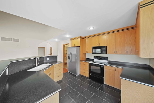 kitchen featuring black appliances, dark tile patterned floors, light brown cabinets, and sink