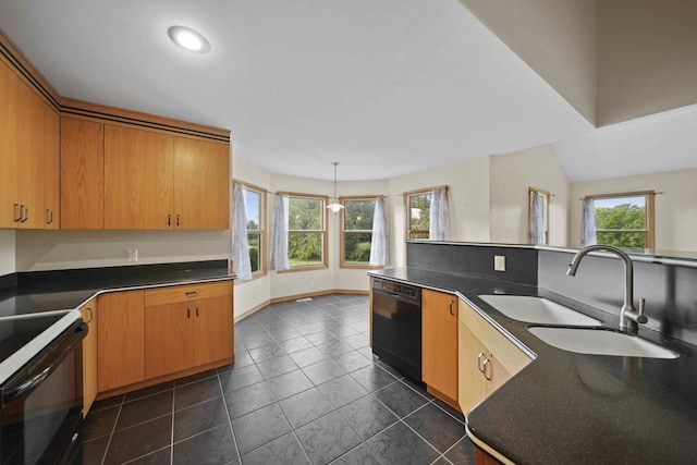 kitchen with black appliances, sink, dark tile patterned flooring, and decorative light fixtures