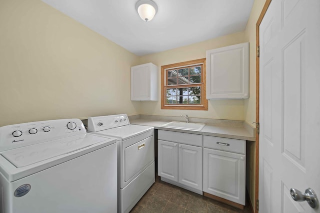 laundry room with cabinets, washing machine and dryer, and sink