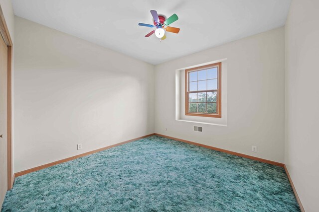 carpeted empty room with ceiling fan