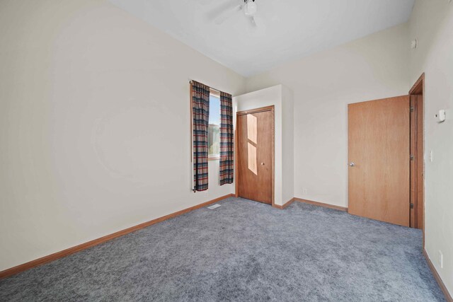 unfurnished bedroom featuring light colored carpet, ceiling fan, and a closet