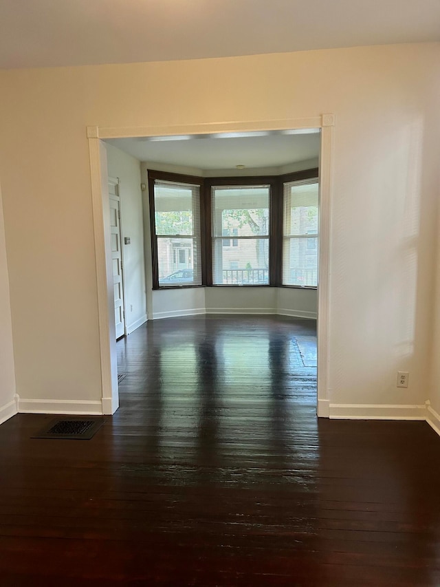 empty room featuring dark wood-type flooring