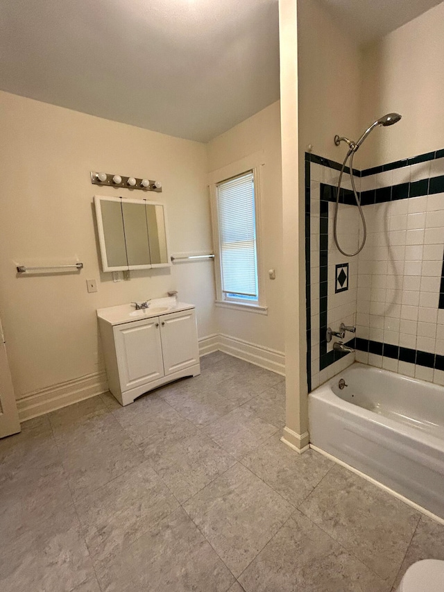 bathroom featuring vanity and tiled shower / bath