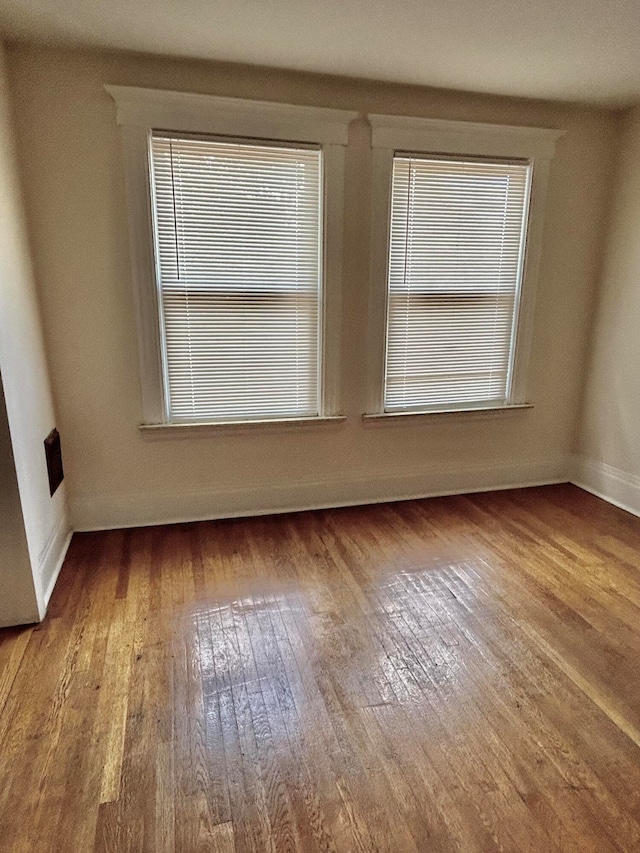 spare room with wood-type flooring