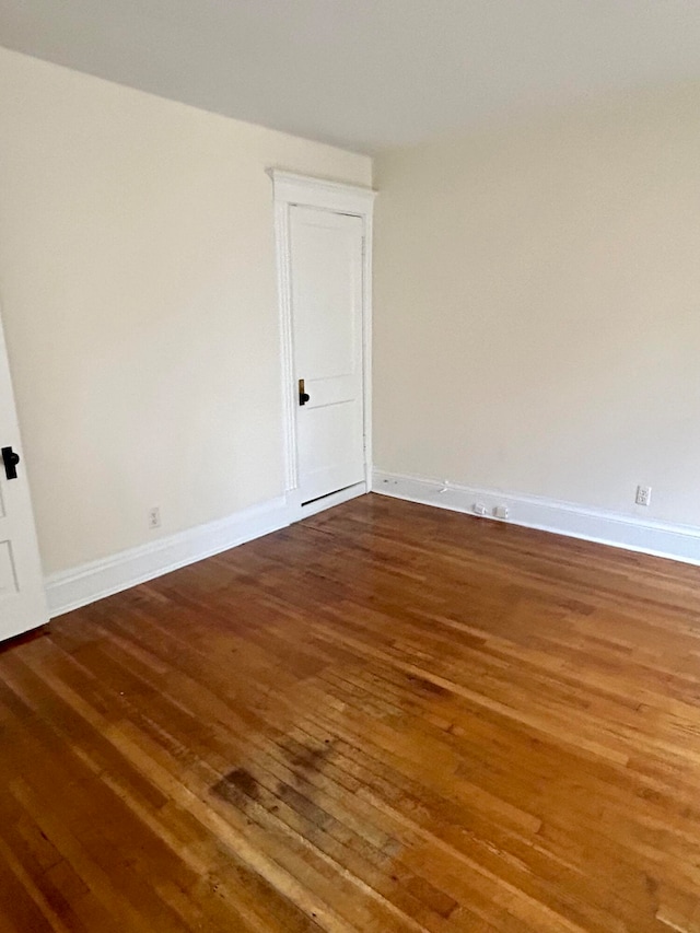 empty room with dark hardwood / wood-style floors