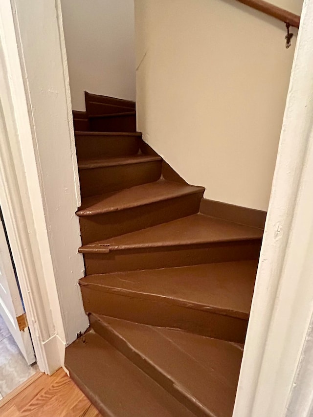 stairs with hardwood / wood-style floors